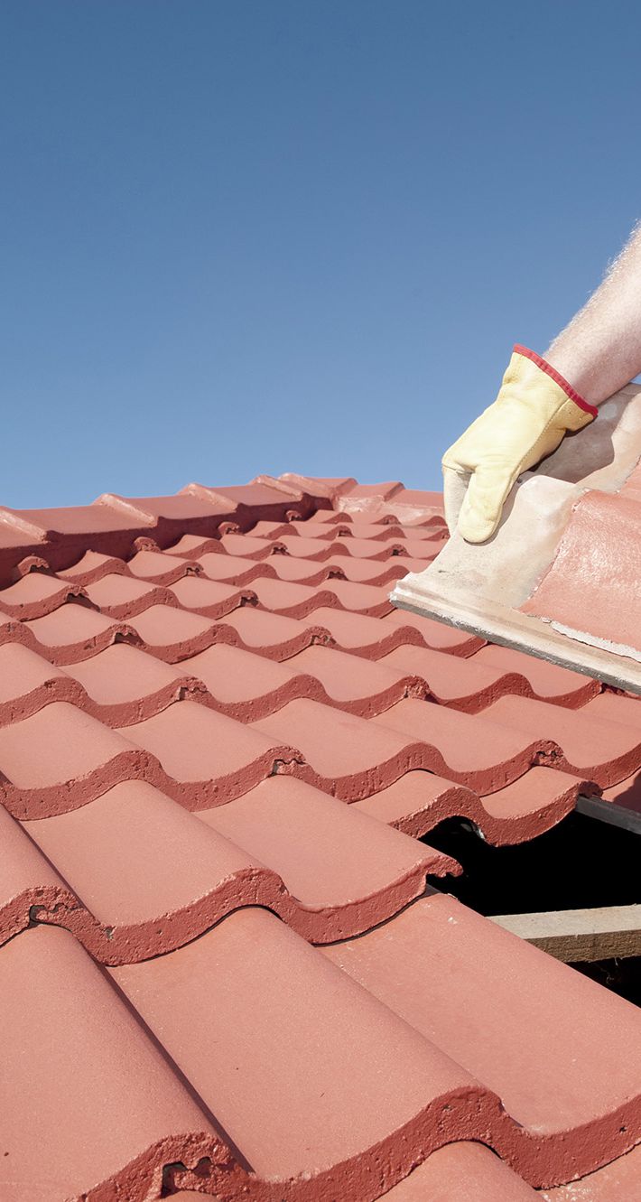 Construction worker tile roofing repair