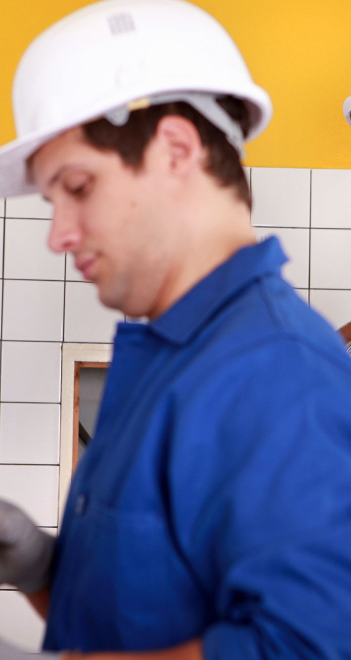Electricians plumbing a bathroom